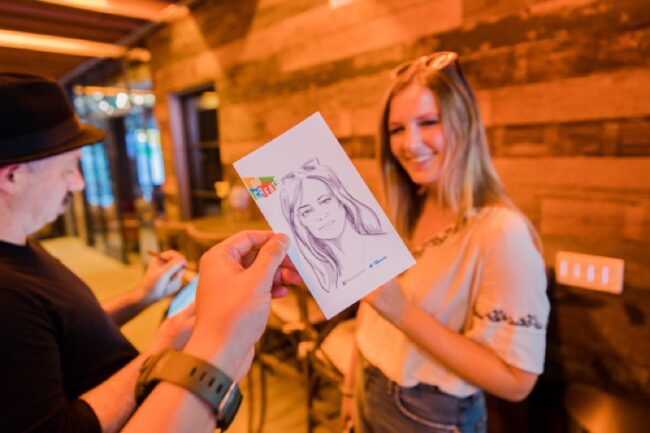 live event illustrator sketched portrait being handed to event guest